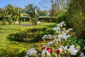 a playground in a park with flowers in the grass at Novotel Porto Gaia in Vila Nova de Gaia