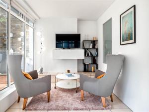 a living room with two chairs and a table at D8 - Hoxton Square Penthouse in London