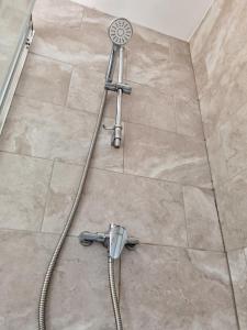 a shower in a bathroom with a shower head at Perry Road, beautiful large house available for Guests and Contractors Parking wifi in Nottingham +57 photos