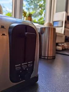 a toaster sitting on a counter next to a trash can at Perry Road, beautiful large house available for Guests and Contractors Parking wifi in Nottingham