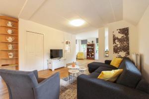 sala de estar con 2 sofás y TV en Vakantiehuis Villa 32, en Heel