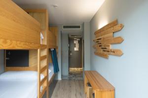 a bedroom with a bunk bed and a desk at Yeah Barcelona Hostel in Barcelona