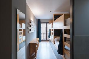 a room with wooden bunk beds and a bedroom at Yeah Barcelona Hostel in Barcelona