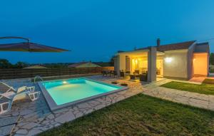 a swimming pool in the backyard of a house at Holiday Home Casa Vida in Rakalj
