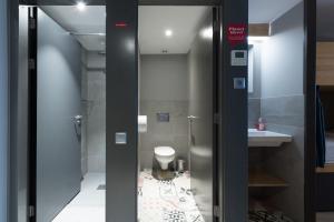 a bathroom with a toilet and a sink at Yeah Barcelona Hostel in Barcelona