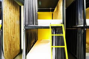 a room with two bunk beds with a yellow ladder at Room 22 in Bangkok