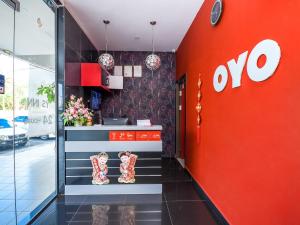 a store with an ovo sign on the wall at OYO 89301 Ys Inn in Miri