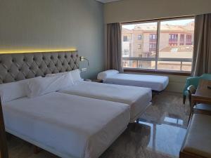 Кровать или кровати в номере Hotel Bahía de Vigo