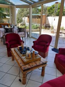 a living room with a coffee table and chairs at Au bon Vivant in Dampierre-sur-Salon