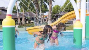 two girls in the water at a water park at MI CAPRICHO 2F BEACHFRONT- Apartment with sea view - Costa del Sol in Sitio de Calahonda
