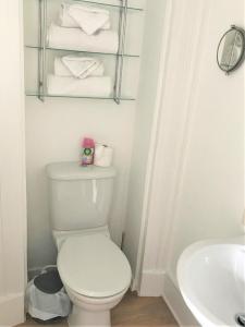 a bathroom with a toilet and a sink and towels at Invercloy Guest House in Oban