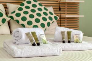 2 Handtücher auf dem Bett mit Büchern in der Unterkunft Appartement Mansana - Welkeys in Caluire-et-Cuire