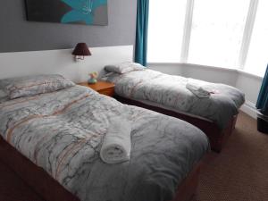 A bed or beds in a room at Jasmine Guest House 