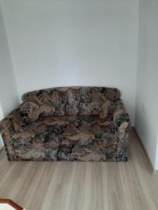 a couch sitting in a corner of a room at Guest House Damyanov in Ravda