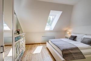 a bedroom with a large bed and a skylight at Herrenhaus am Erlaufsee - DorfResort Mitterbach in Mariazell