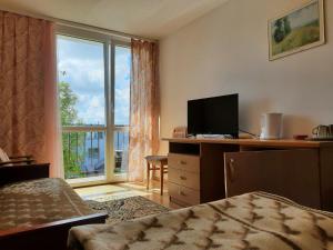 a hotel room with a bed and a window at OW Żeglarz in Jastrzębia Góra