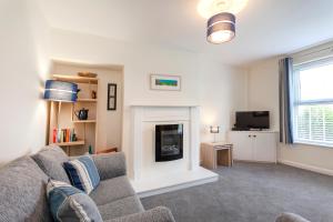 a living room with a couch and a fireplace at CRANBROOK 28 in Nottingham