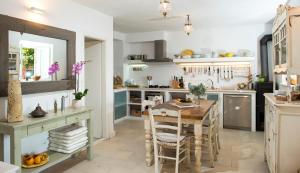 a kitchen with a table and a dining room at Villa Maslina in Cavtat