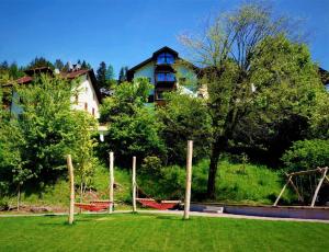 a yard with hammocks in front of a house at Apartment Cesa Collina in Ortisei