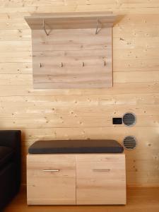 a room with a wooden wall with a bench at Camping Piccolo Paradiso in Avegno