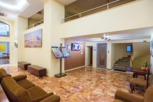 a lobby with couches and a staircase in a building at Hotel Marina in Athens