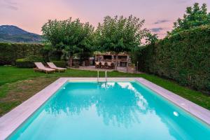 a swimming pool in the backyard of a house at Chariklia's House with private pool in Káto Lekhónia