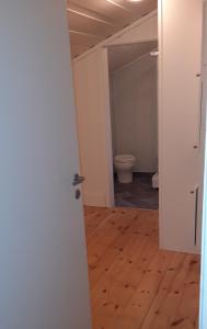 una porta aperta a una stanza vuota con servizi igienici di Granheim Hytte med 2 soverom a Birkeland