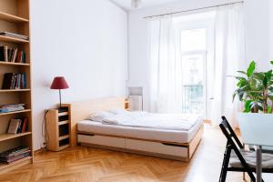 A bed or beds in a room at Comfortable & Spacious Lodz City Center Apartment