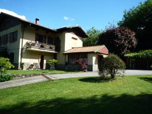 una casa con un cortile verde con una casa di Monolocali In Casa Con Giardino Bellagio a Bellagio