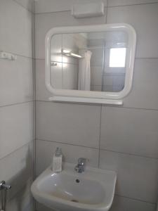 a bathroom with a sink and a mirror at Nefeli in Kalamaki