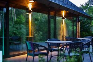 a group of chairs and tables on a deck at Villa Gaida in Saulkrasti