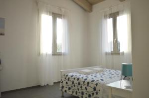 A bed or beds in a room at La Silvana B&B