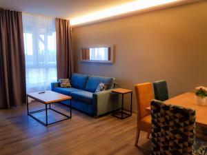 a living room with a couch and a table at Baltic Seaside in Rewal