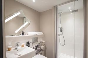 a bathroom with a sink and a shower at ibis budget Nice Californie Lenval in Nice