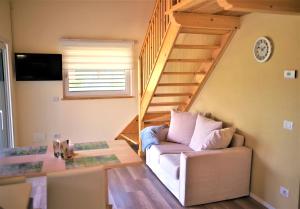 a living room with a couch and a staircase at Casa Alice in Cannobio