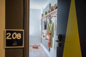 a hallway with a door with a sign on it at ibis budget Nice Californie Lenval in Nice