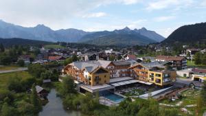 an aerial view of a town with a river and mountains at Hotel Seespitz Seefeld Superior in Seefeld in Tirol