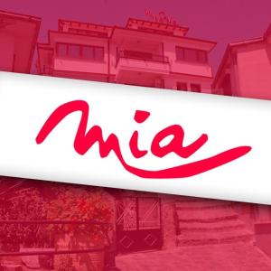 aana logo is shown in front of a pink building at Villa Mia Suites in Ohrid