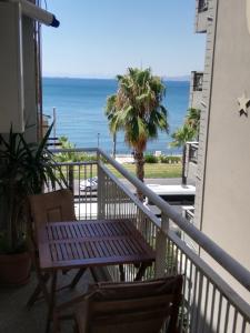 a balcony with a table and a view of the ocean at Athens Riviera apt with seaview, 15' to Acropolis in Athens