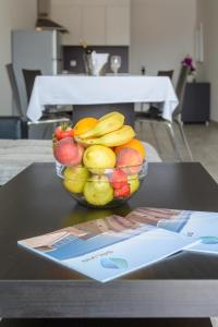 a bowl of fruit sitting on top of a table at Crikvenica Residence Apartments and Rooms in Crikvenica