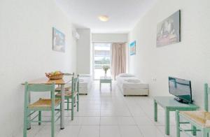 a living room with a table and a couch at Ostria Studios in Rethymno