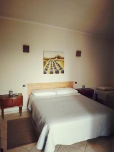 a bedroom with a bed and a painting on the wall at B&B Sud e Magia in San Pietro Infine