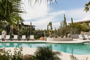 a swimming pool with a pool table and chairs at CIVANA Wellness Resort & Spa in Scottsdale