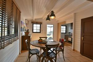 a kitchen and dining room with a table and chairs at Cirasa Luxury Country House in Trecastagni