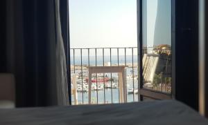 a bedroom with a bed and a view of the ocean at Hotel Trias in Palamós
