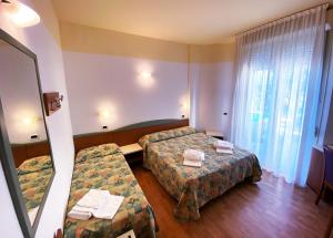 Postel nebo postele na pokoji v ubytování Hotel Diplomatic