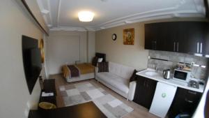 a small living room with a couch and a kitchen at Lena Central Flats in Bursa