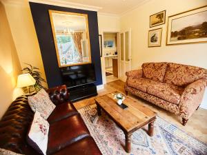 a living room with a couch and a coffee table at MOONRIVER Ironbridge in Telford