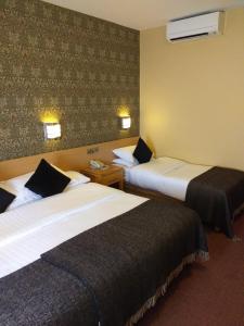 a hotel room with two beds in a room at Harding Hotel in Dublin +16 photos