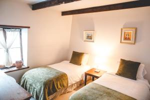Katil atau katil-katil dalam bilik di Le Clos des Brumes